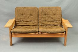 YNGVE EKSTROM FOR SWEDESE, a low oak framed two seater sofa, with shaped armrests and canvas seats