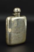 A GEORGE V SILVER HIP FLASK, of bowed rectangular form, bayonet fitting to hinged cover, engraved