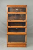 A GLOBE WERNICKE WALNUT FIVE SECTIONAL BOOKCASE, with glazed fall front doors, comprising of four