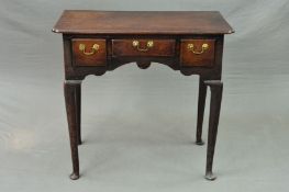 A GEORGE III OAK SIDE TABLE, of rectangular form, fitted with three frieze drawers above a wavy