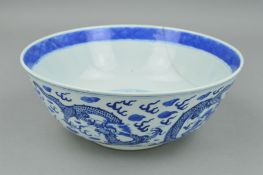 A CHINESE QING DYNASTY BLUE AND WHITE BOWL, decorated with a continuous band of five four clawed