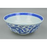 A CHINESE QING DYNASTY BLUE AND WHITE BOWL, decorated with a continuous band of five four clawed