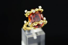 A MID TO LATE 20TH CENTURY ORNATE ABSTRACT CITRINE AND DIAMOND DRESS RING, centring on an oval mixed