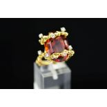 A MID TO LATE 20TH CENTURY ORNATE ABSTRACT CITRINE AND DIAMOND DRESS RING, centring on an oval mixed