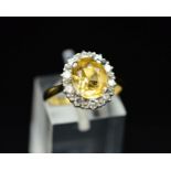 A MID 20TH CENTURY GOLDEN TOPAZ AND DIAMOND OVAL CLUSTER RING, oval mixed cut topaz measuring