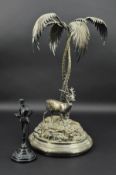 A LATE VICTORIAN SILVER PLATED CENTREPIECE, in the form of a Stag beneath two twisted palm trees,