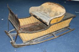 A 19TH CENTURY HORSE DRAWN SLEIGH, in need of restoration, fitted with part upholstered seat for two