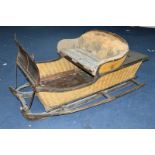A 19TH CENTURY HORSE DRAWN SLEIGH, in need of restoration, fitted with part upholstered seat for two