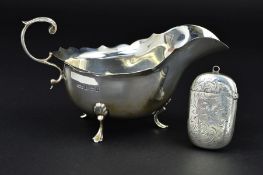 A LATE VICTORIAN SILVER VESTA CASE, of rounded rectangular form, foliate engraved decoration,