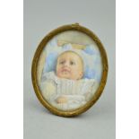 EARLY 20TH CENTURY PORTRAIT MINIATURE OF A BABY, wearing broiderie anglaise gown, head resting on