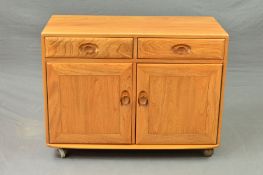 AN ERCOL BLONDE ELM SIDEBOARD, with two drawers above a double cupboard door base on orbit