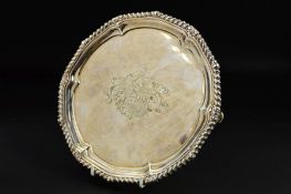 A GEORGE III PAUL STORR SILVER SALVER, gadrooned and pie crust rim, the centre engraved with coat of
