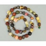 A STRING OF FIFTY-ONE 19TH/20TH CENTURY JAPANESE OJIME BEADS IN WOOD, HORN, HARDSTONE, PORCELAIN,