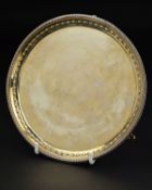 A GEORGE III HESTER BATEMAN SILVER SALVER, beaded rim, embossed husk border on three beaded feet,