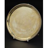 A GEORGE III HESTER BATEMAN SILVER SALVER, beaded rim, embossed husk border on three beaded feet,