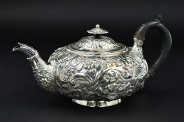 A GEORGE IV SILVER TEAPOT, of flattened circular form, flower head shaped finial above hinged