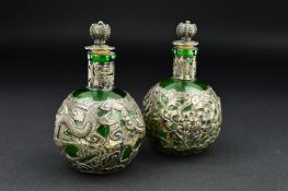 A MATCHED PAIR OF CHINESE EXPORT SILVER COVERED GREEN GLASS SCENT BOTTLES, of bulbous form, one with