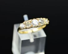 A LATE VICTORIAN DIAMOND CARVED HALF HOOP RING, five old cut diamonds graduating in size from 3.