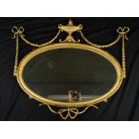 A 19TH CENTURY NEO-CLASSICAL STYLE GILT WOOD OVAL OVERMANTEL MIRROR, with twin handled urn surmount,