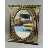 A VICTORIAN EBONISED AND GILT OVERMANTEL MIRROR, the rectangular frame with moulded pediment and