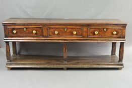 AN EARLY 18TH CENTURY OAK DRESSER, the moulded edge above three short drawers with replacement