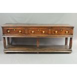 AN EARLY 18TH CENTURY OAK DRESSER, the moulded edge above three short drawers with replacement