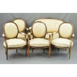 A LATE 19TH CENTURY SALON SUITE, of Louis XVI style, comprising a canape and four fauteuils, each