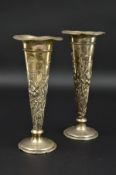 A PAIR OF EDWARDIAN WILLIAM COMYNS SILVER POSY VASES, of conical form, embossed with reeds, irises