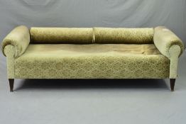 AN EARLY 20TH CENTURY GERMAN DAY BED, scrolled ends, with a pair of bolster cushions which can act