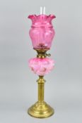 A LATE VICTORIAN BRASS BASED OIL LAMP, with chimney, the cranberry glass shade with acid etched