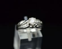 A MODERN PLATINUM DIAMOND RING, centring on a principle modern round brilliant cut diamond,