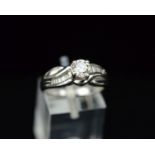 A MODERN PLATINUM DIAMOND RING, centring on a principle modern round brilliant cut diamond,