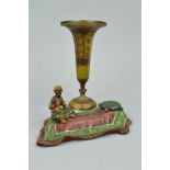 AN EARLY 20TH CENTURY PAINTED METAL INKWELL, in the form of an Arab, cast as seated smoking on a