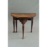A GEORGE II OAK FOLD OVER COUNTRY TEA TABLE, of Demi Lune shape, on a triangular base with wavy