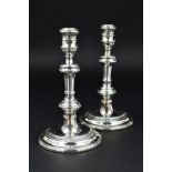 A PAIR OF ELIZABETH II SILVER CANDLESTICKS OF GEORGE I STYLE, turned knopped columns, stepped