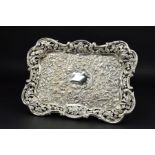 AN EDWARDIAN SILVER DRESSING TABLE TRAY, of shaped rectangular form, pierced border, central blind