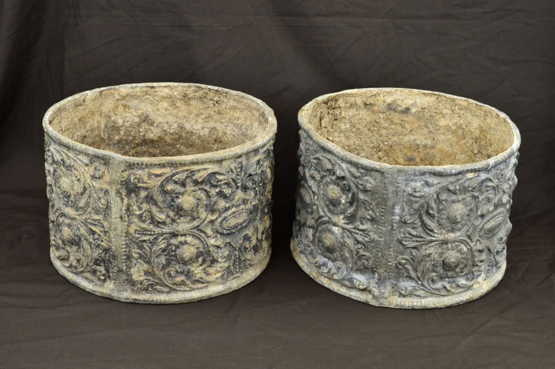 A PAIR OF CIRCULAR LEAD PLANTERS, the exteriors cast with foliate scrolls, flower heads and