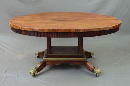 AN EARLY 19TH CENTURY MAHOGANY OVAL CENTRE TABLE, with fluted frieze, four block supports to a