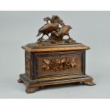 A LATE 19TH CENTURY BLACK FOREST TEA CADDY, or rectangular form, the hinged cover carved with two