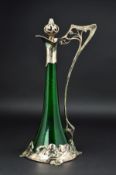 AN ART NOUVEAU WMF CLARET JUG, the conical green glass body with openwork stopper and handle cast