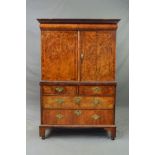 A GEORGE I WALNUT CABINET ON CHEST, the pediment above a cushion moulded frieze drawer, double