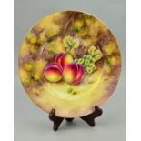 A ROYAL WORCESTER PLATE HAND PAINTED WITH PEACHES AND GRAPES ON A MOSSY BANK, bears signature for