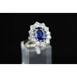 A MODERN LARGE OVAL SAPPHIRE AND DIAMOND CLUSTER RING, sapphire measuring approximately 10.0mm x 8.