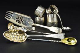 A PAIR OF GEORGE III SILVER BERRY SPOONS, with repousse decorated and gilded bowls, foliate engraved