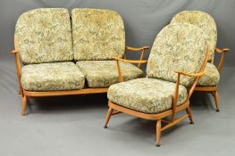 AN ERCOL BLONDE ELM THREE PIECE LOUNGE SUITE, with stick back and shaped armrests, comprising of a