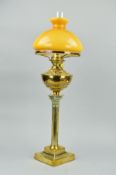 A LATE VICTORIAN BRASS CORINTHIAN COLUMN OIL LAMP, with chimney, opaque mustard coloured glass