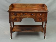 A VICTORIAN MAHOGANY WASHSTAND, the rectangular top with raised back and sides above an