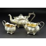 A GEORGE V THREE PIECE SILVER BACHELORS TEASET, of wavy oval outline, engraved foliate