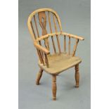 A 19TH CENTURY CHILD'S WINDSOR ELBOW CHAIR, in ash and beech, pierced vase splat and plain spindles,