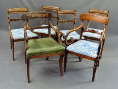 A REGENCY MAHOGANY ELBOW CHAIR, the top rail with shallow carved ends, back, arms and sabre legs